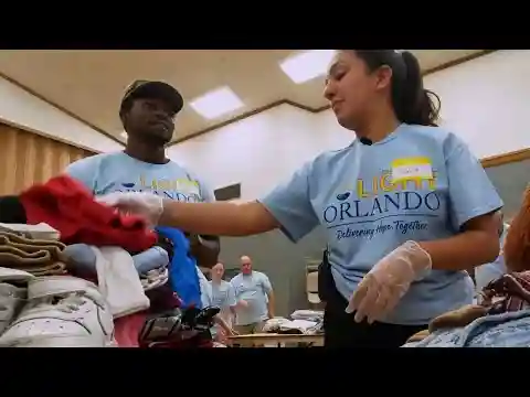 Light Orlando volunteers sort clothes for Central Floridians in need