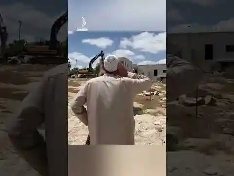 Palestinian man recites call to prayer in front of Israeli bulldozers