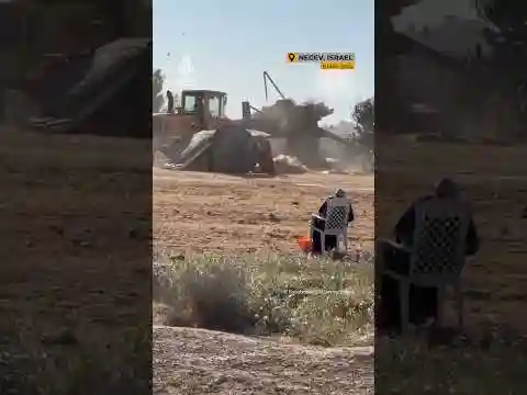 Palestinian woman watches Israeli demolition of her house