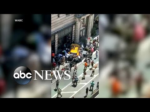 NYC cab jumps curb, strikes passengers on busy street