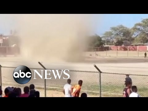 Soccer match interrupted by whirlwind on the pitch