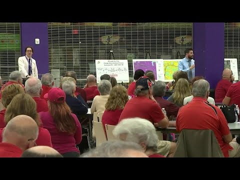 Residents wear red to show displeasure of housing development on golf course